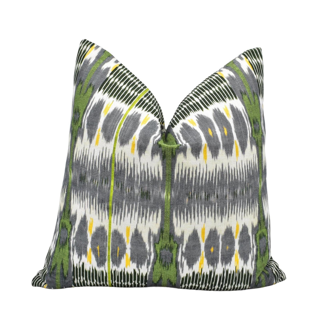a decorative pillow with a repeating pattern of green and gray stripes and yellow accents.