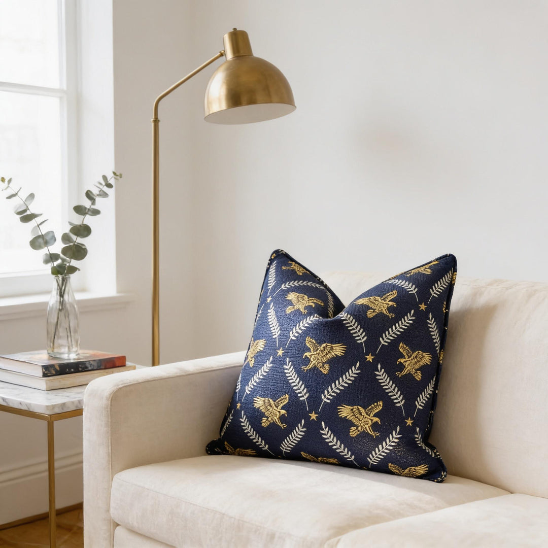 a cozy living room with a white sofa, a gold floor lamp, and a decorative pillow with a blue and gold pattern.