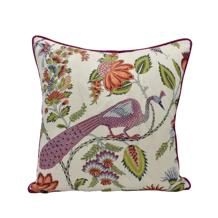 A decorative throw pillow with a vibrant floral and peacock motif.
