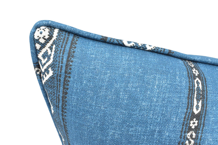 a close up of a blue pillow with a pattern on it