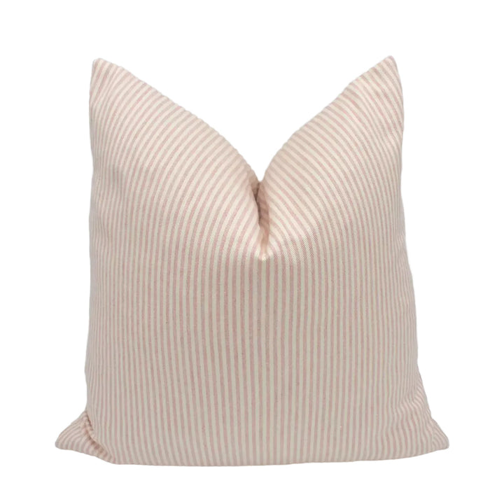 A single pillow with a striped pattern in shades of peach and white.