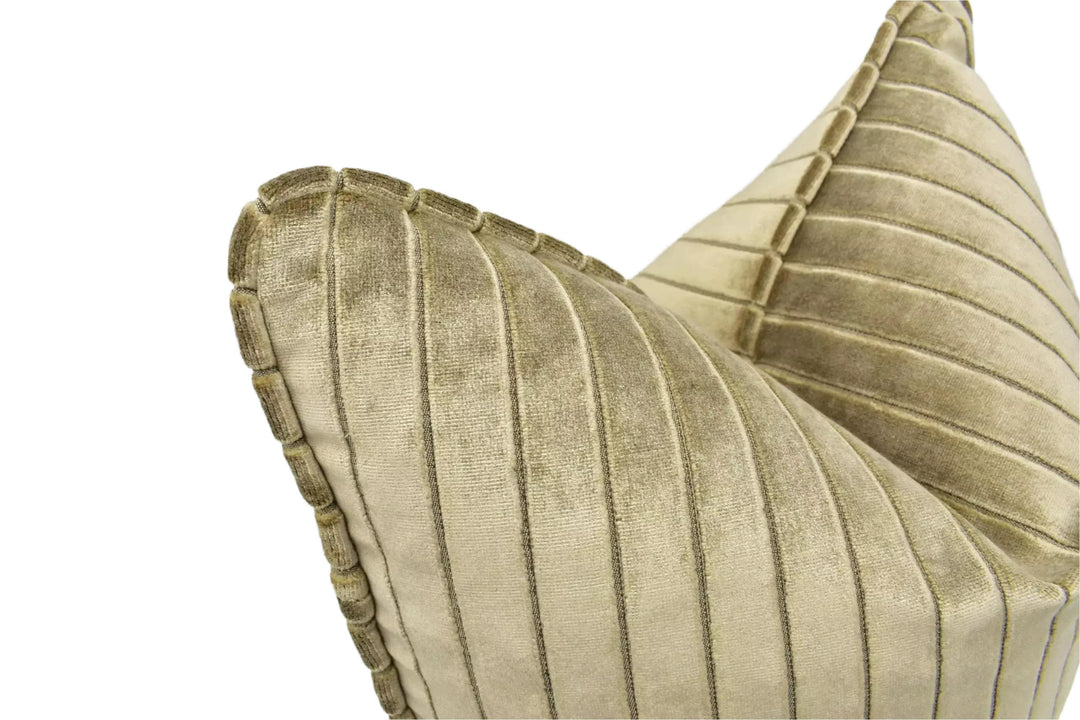 A close-up view of a beige, textured pillow with a striped pattern.