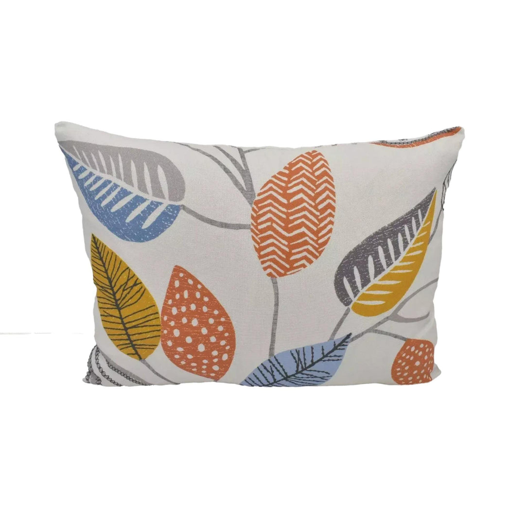 a white pillow with a colorful leaf pattern printed on it.