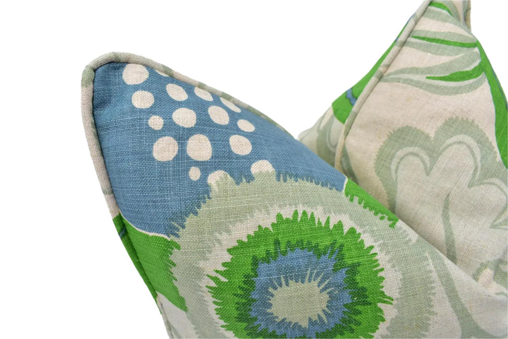 a close-up view of a decorative pillow with a vibrant, colorful floral pattern in shades of blue, green, and white.