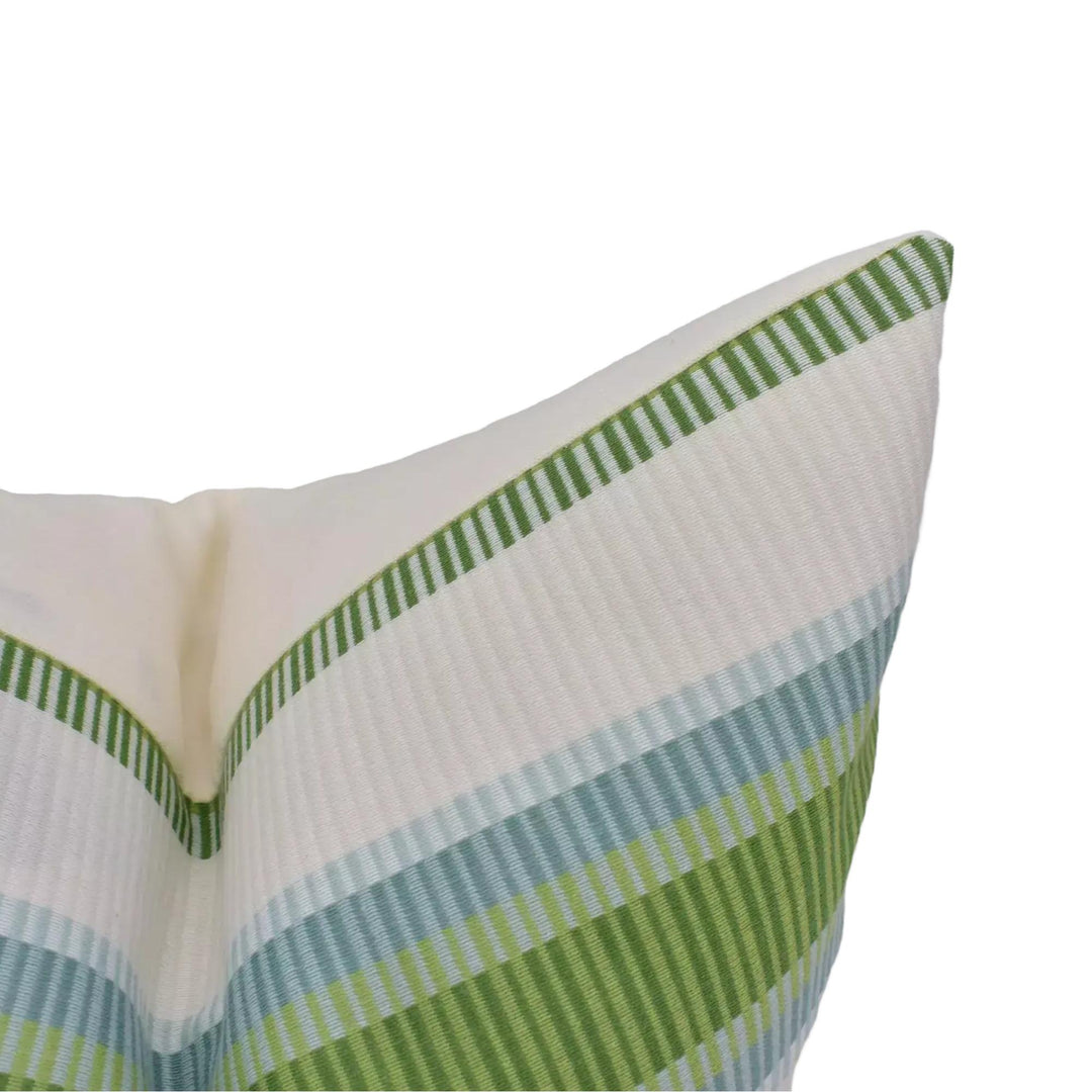 A close-up view of a white and green striped pillow with a pointed top.