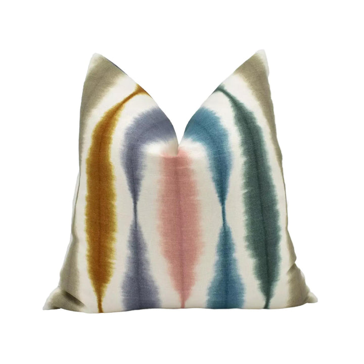a colorful, tie-dye pillow with a vibrant pattern of stripes in various colors.