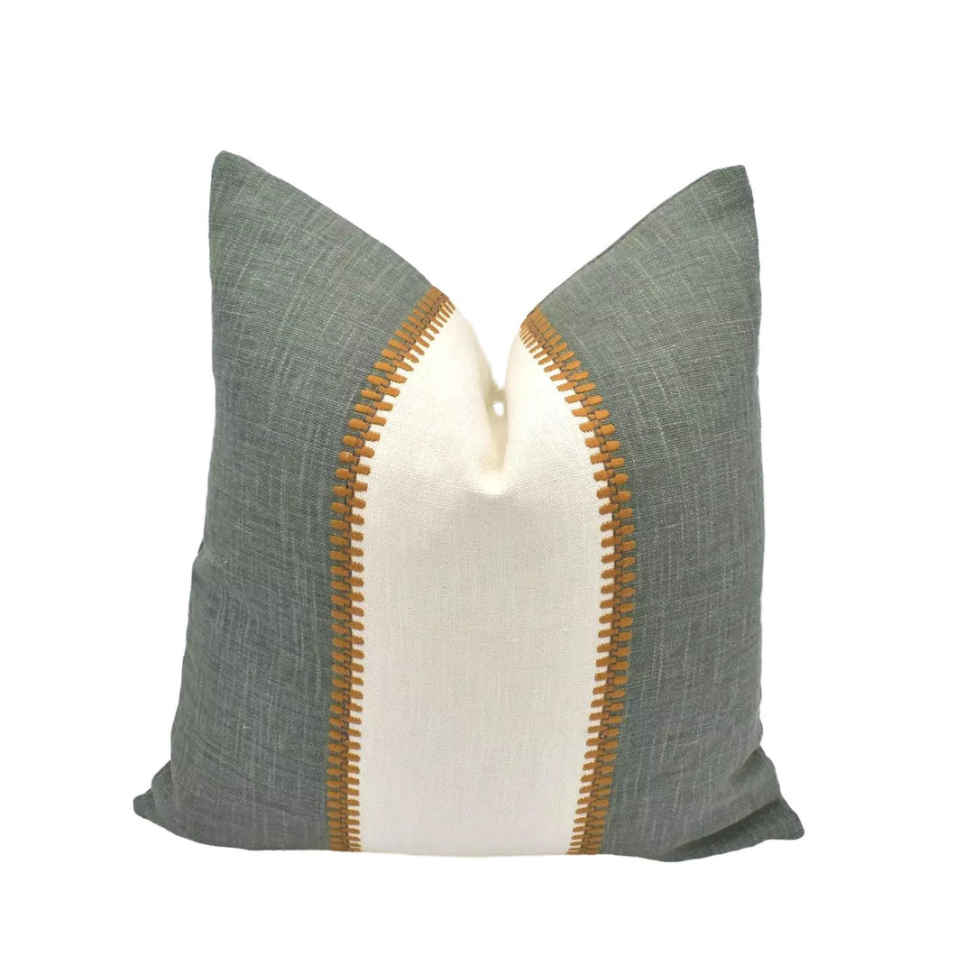 A green and white throw pillow with a decorative stripe on the side is displayed against a white background.