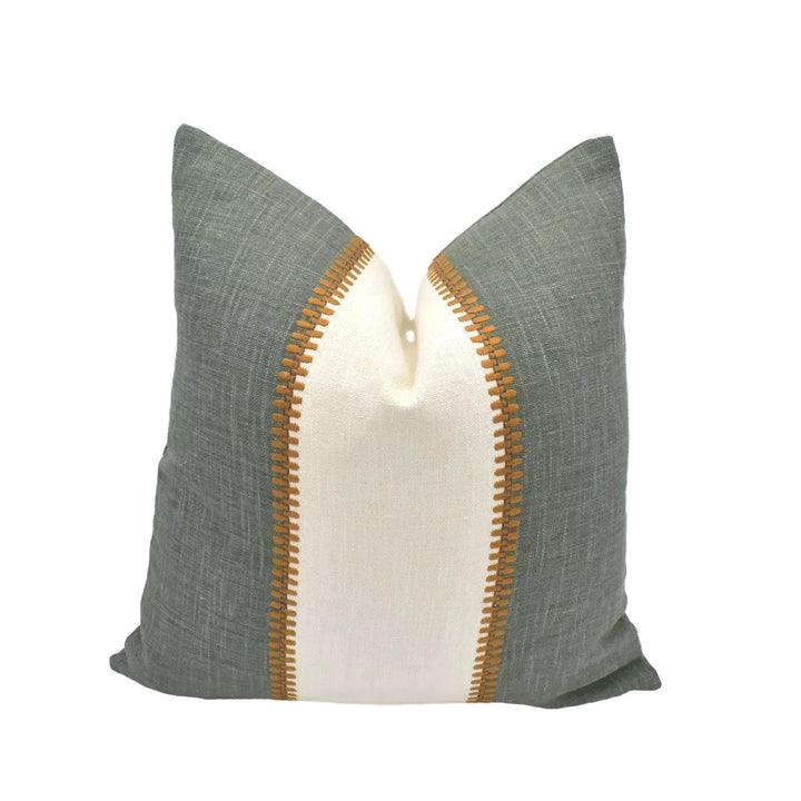 A green and white throw pillow with a decorative stripe on the side is displayed against a white background.