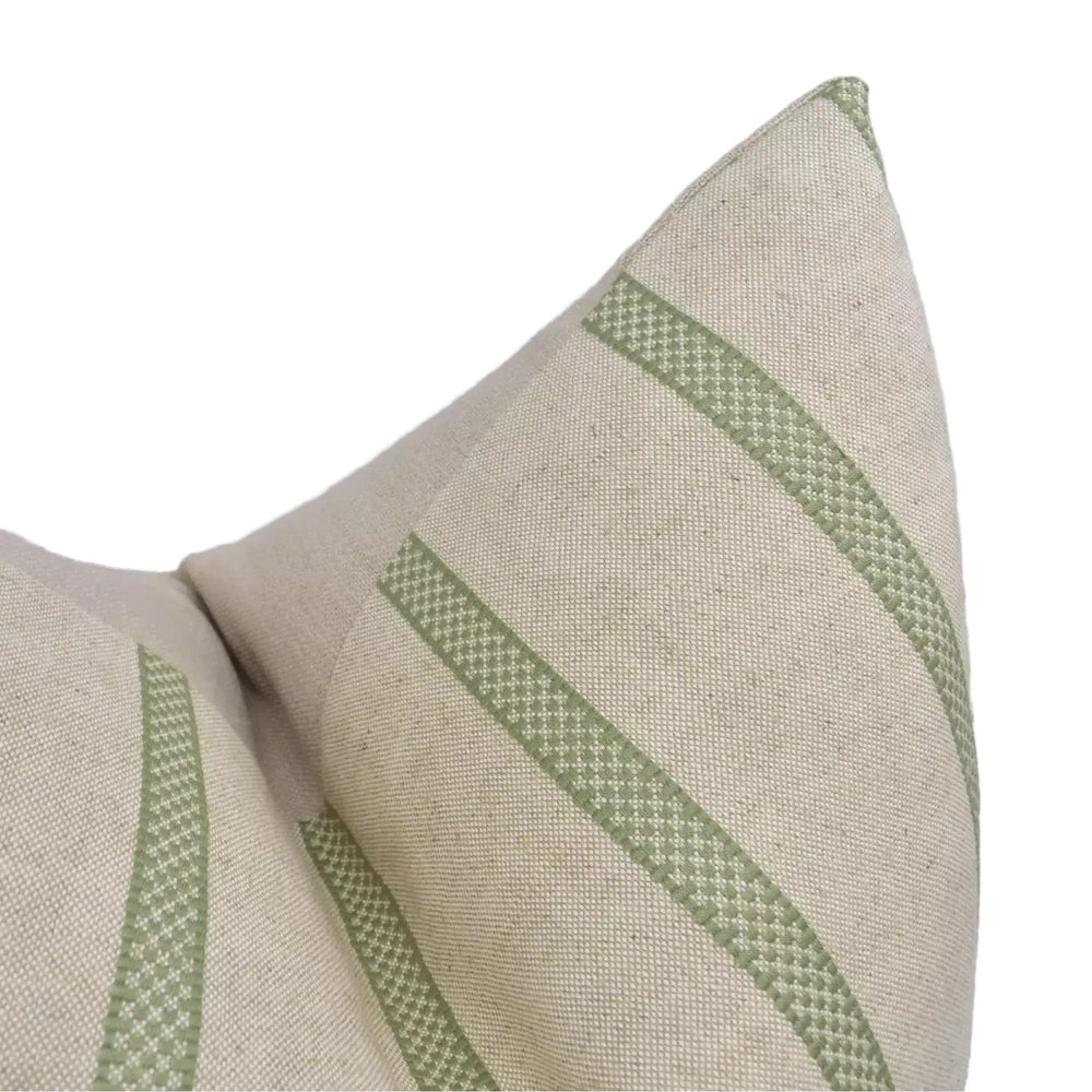 A close-up view of a beige fabric with green diagonal stripes, creating a textured and patterned appearance.