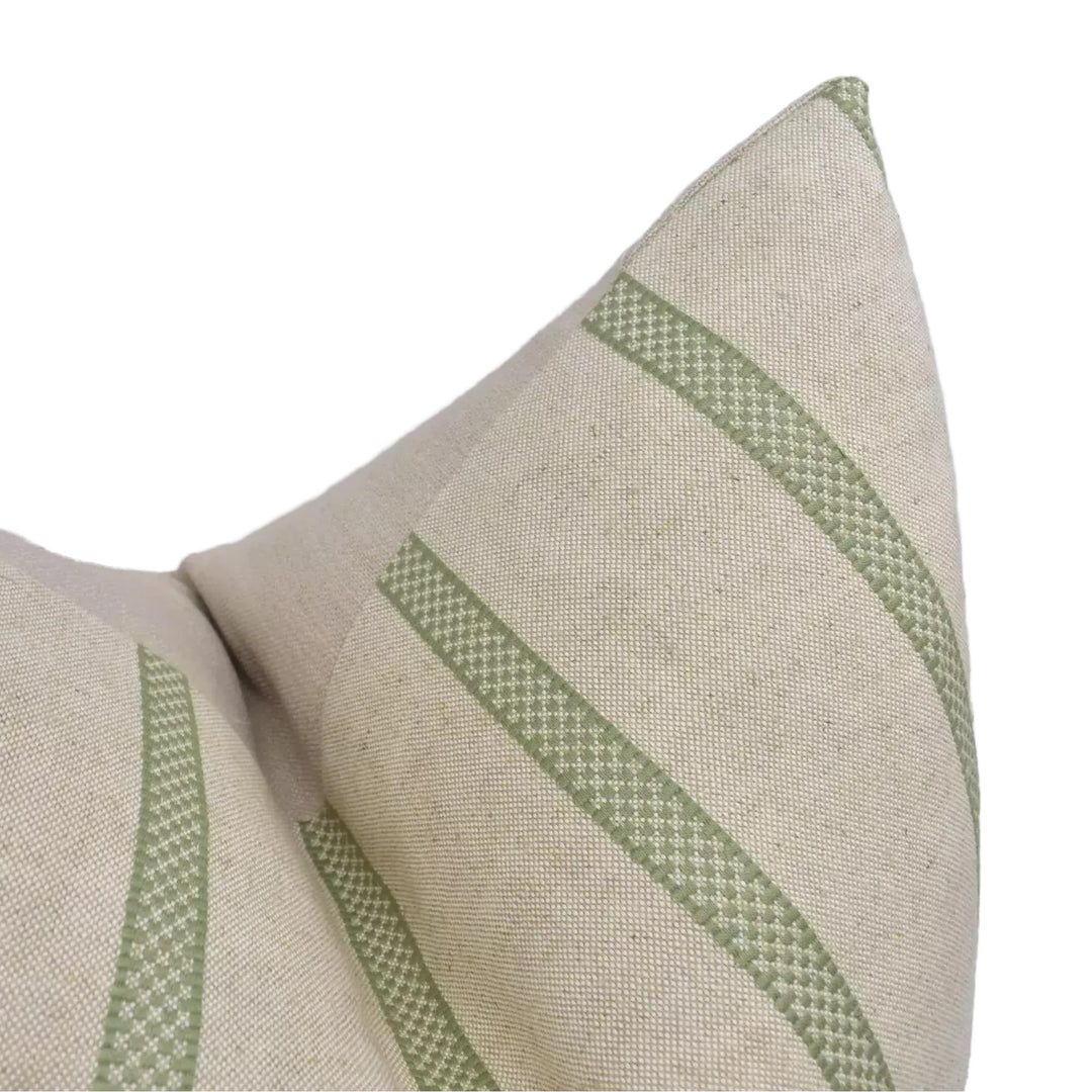 A close-up view of a beige fabric with green diagonal stripes, creating a textured and patterned appearance.