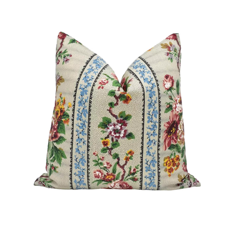 A decorative throw pillow with a floral pattern in various colors, including red, yellow, and green.