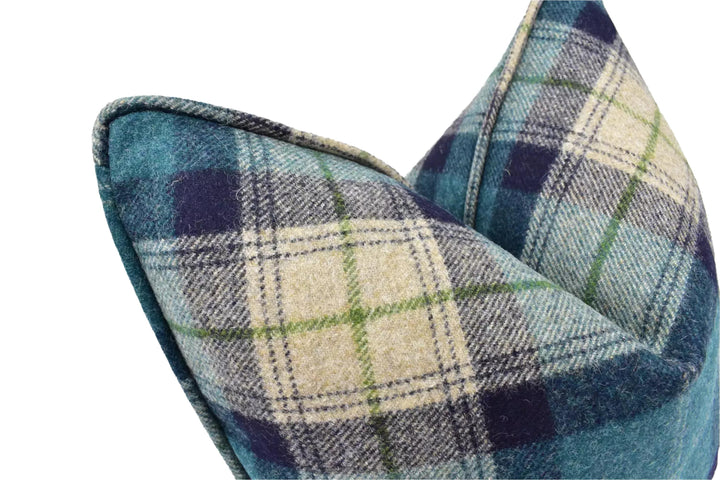 A close-up view of a plaid pillow with a blue and green plaid pattern.