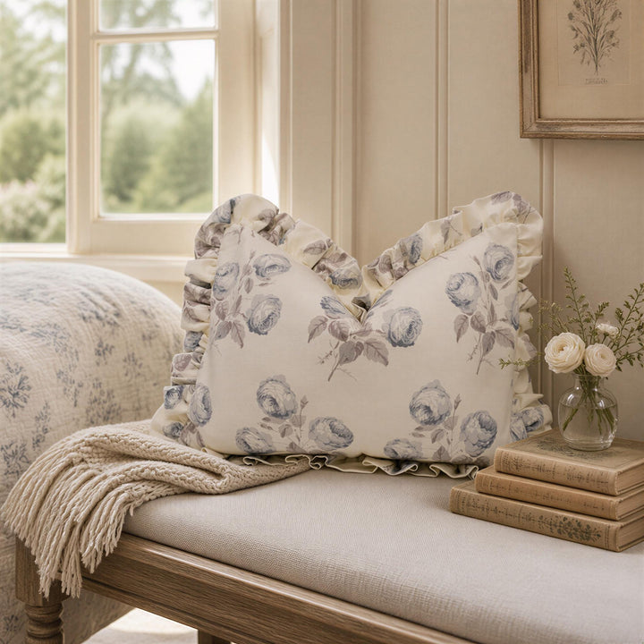 a pillow on a bench next to a window