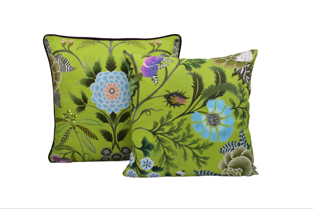 a pair of green floral pillows on a white background