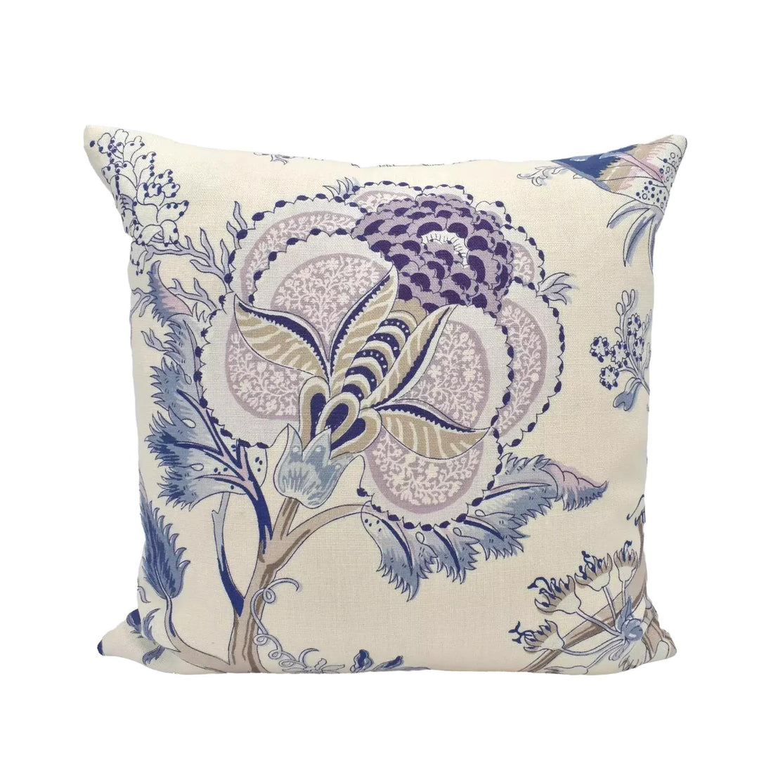 A decorative throw pillow with a floral pattern in shades of blue and purple.