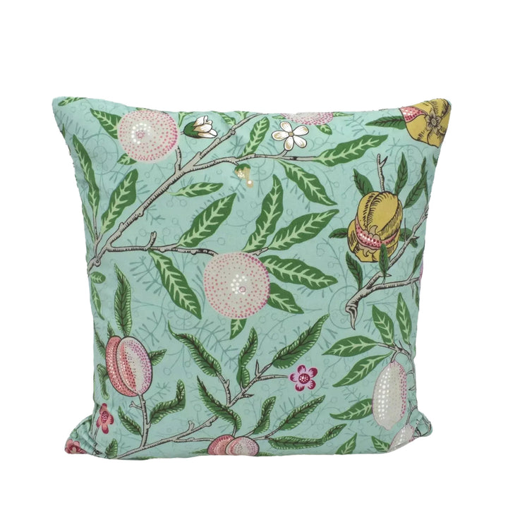 A square throw pillow with a vibrant floral pattern in shades of green and pink, featuring various fruits and leaves.