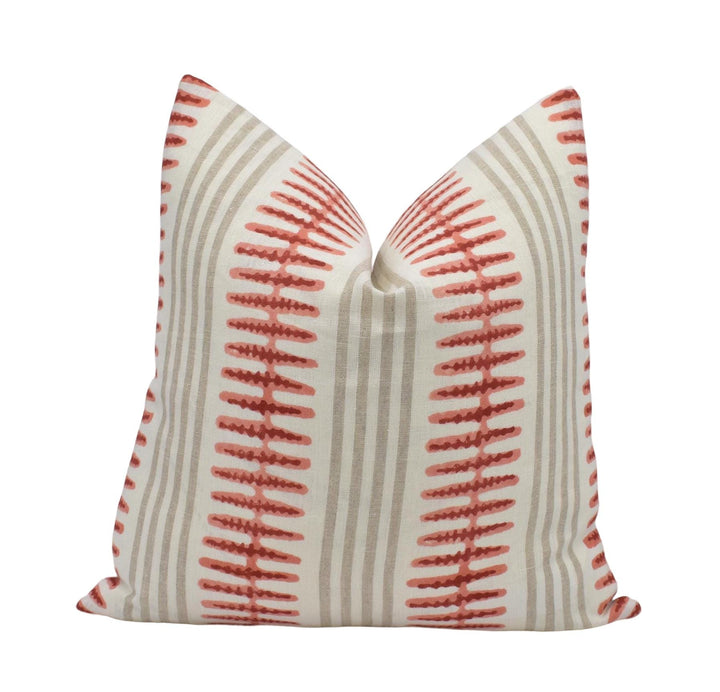 a single pillow with a striped pattern in shades of gray and red.
