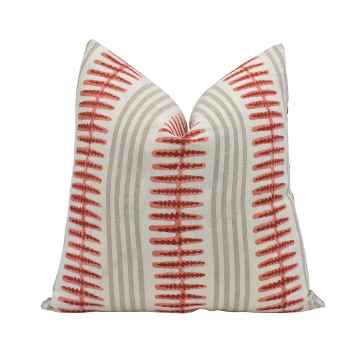 a single pillow with a striped pattern in shades of red and gray.