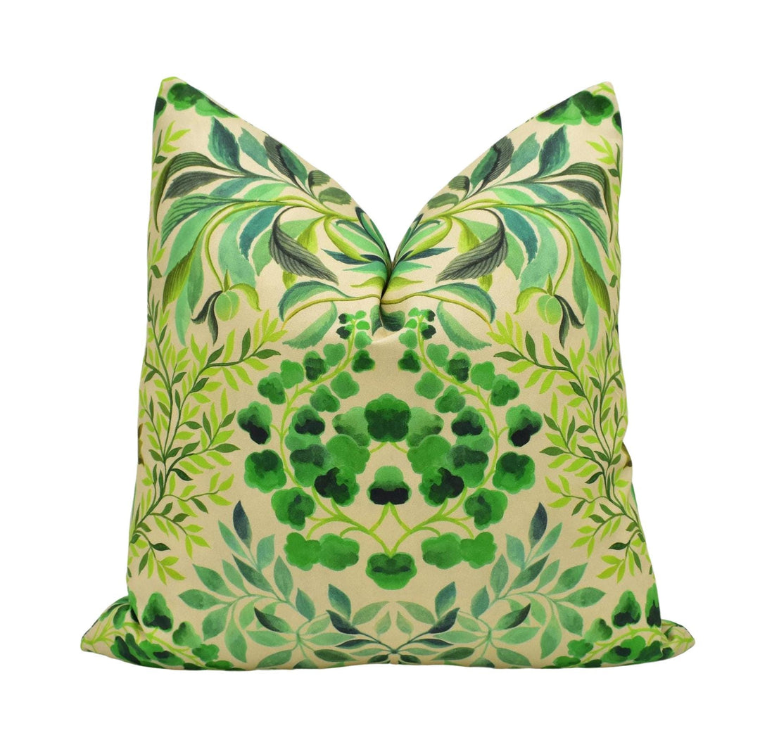 A decorative pillow with a green leaf pattern and a floral design.