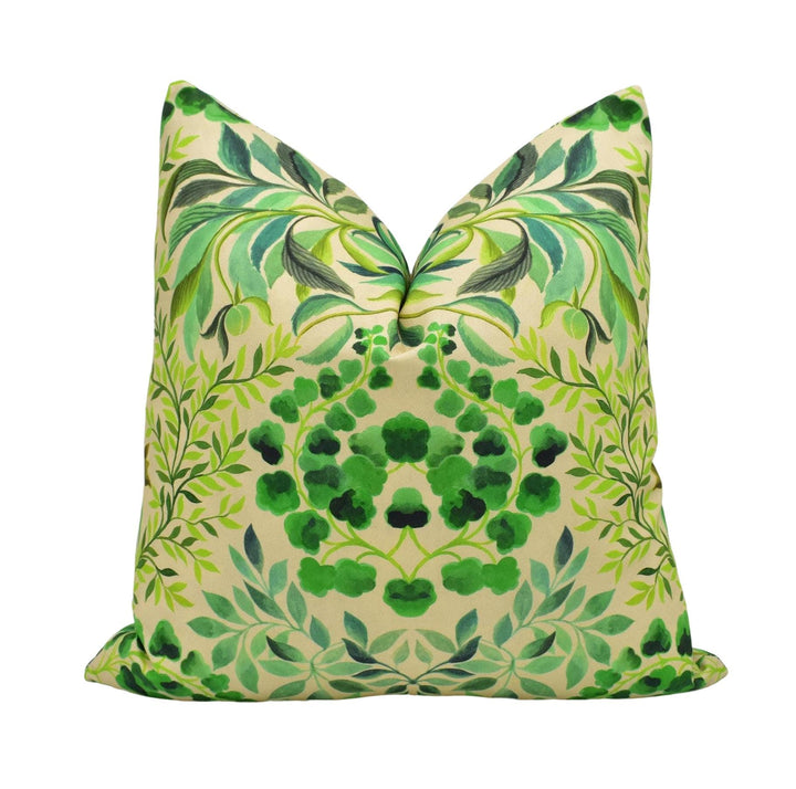 A decorative pillow with a green leaf pattern and a floral design.