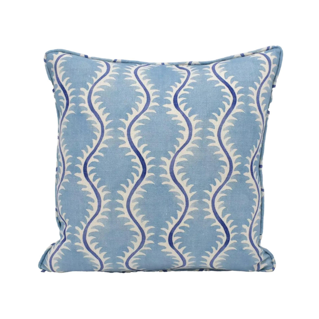 A blue and white patterned throw pillow with a repeating design of blue and white swirls.