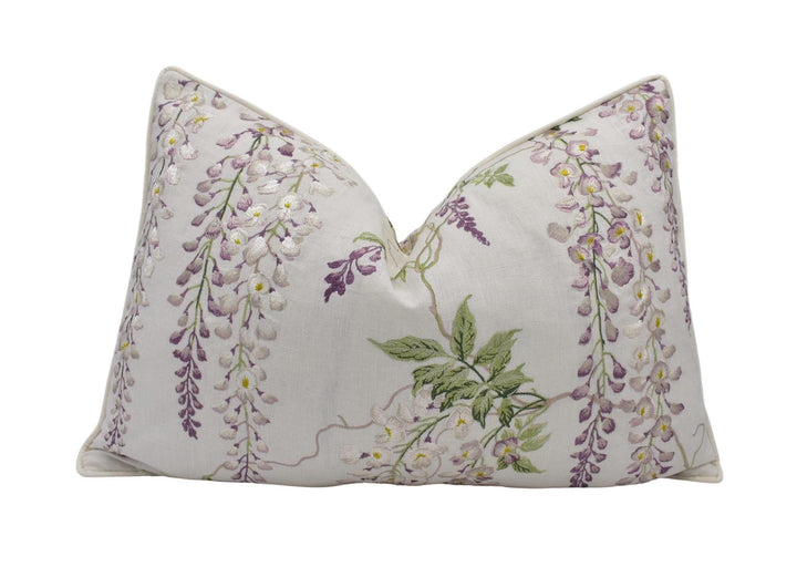 a white pillow with purple flowers on it