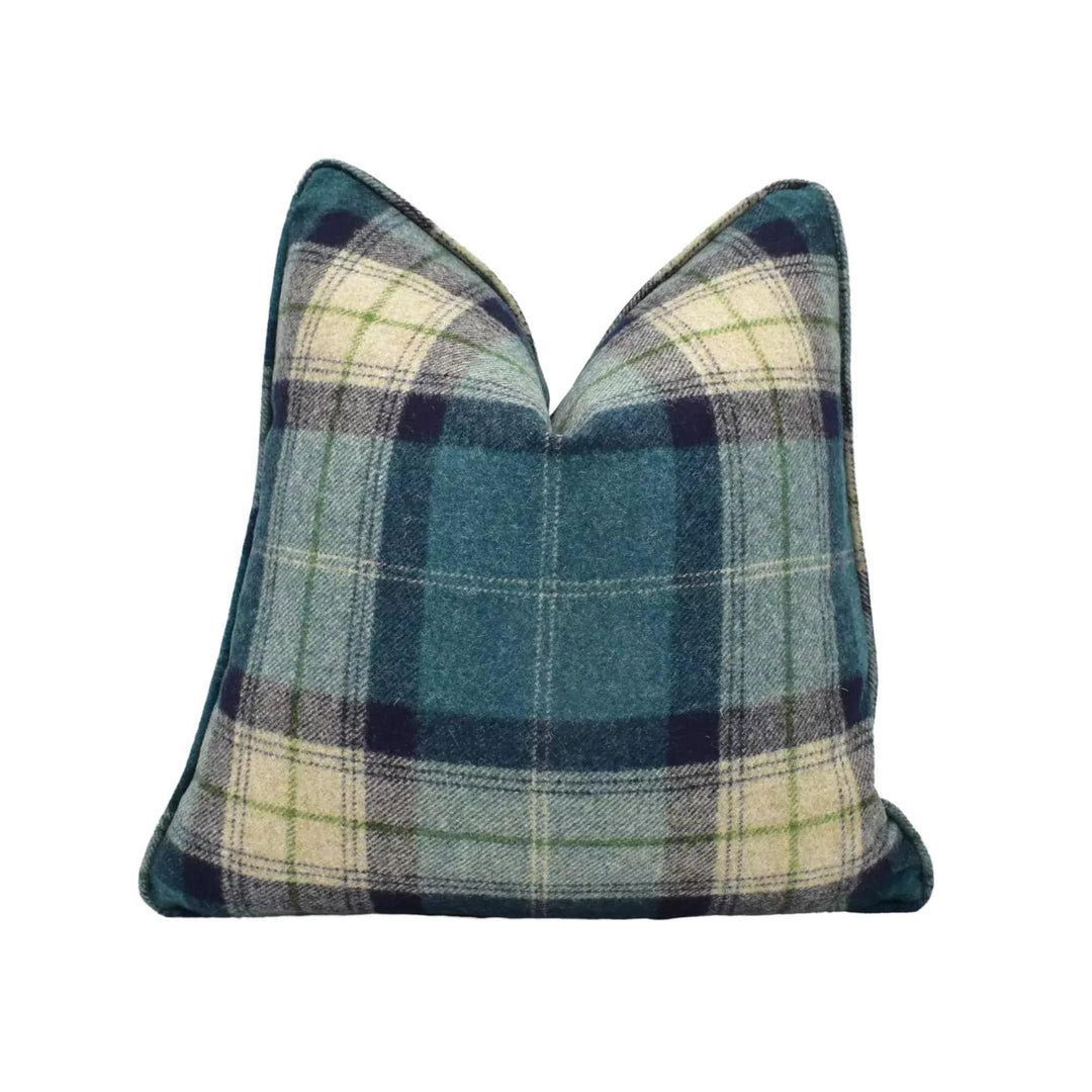 A blue and green plaid throw pillow against a white background.