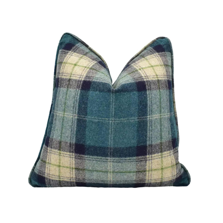 A blue and green plaid throw pillow against a white background.