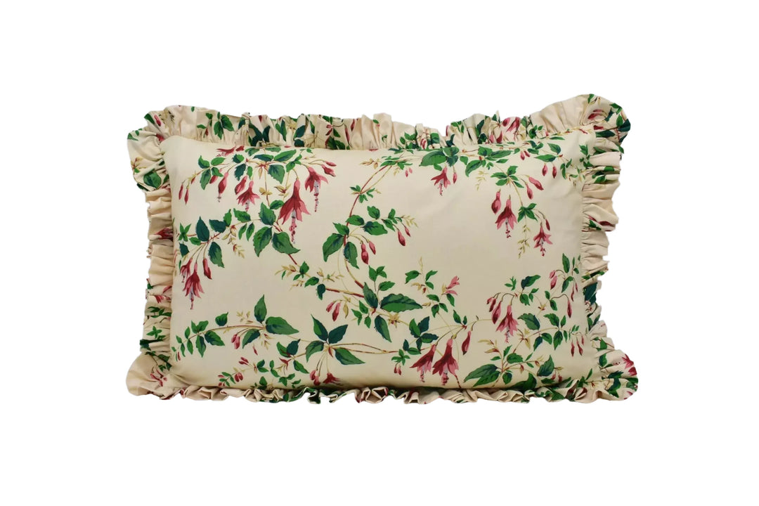A decorative pillow with a floral print design on a beige background.