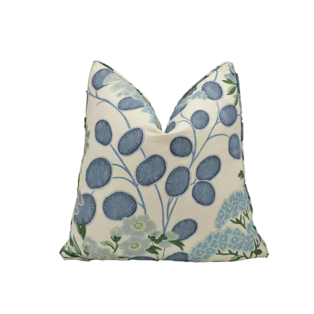 A decorative throw pillow with a floral pattern in shades of blue and white.