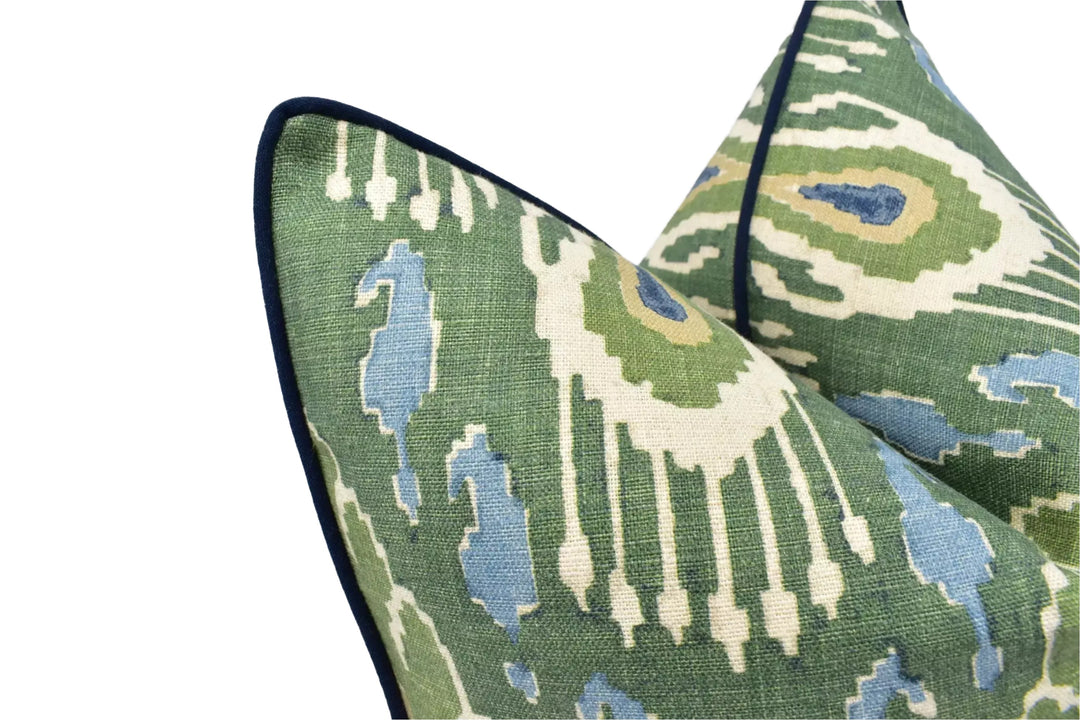 a close-up view of a green and white patterned fabric, possibly a pillow or cushion, with a black border.