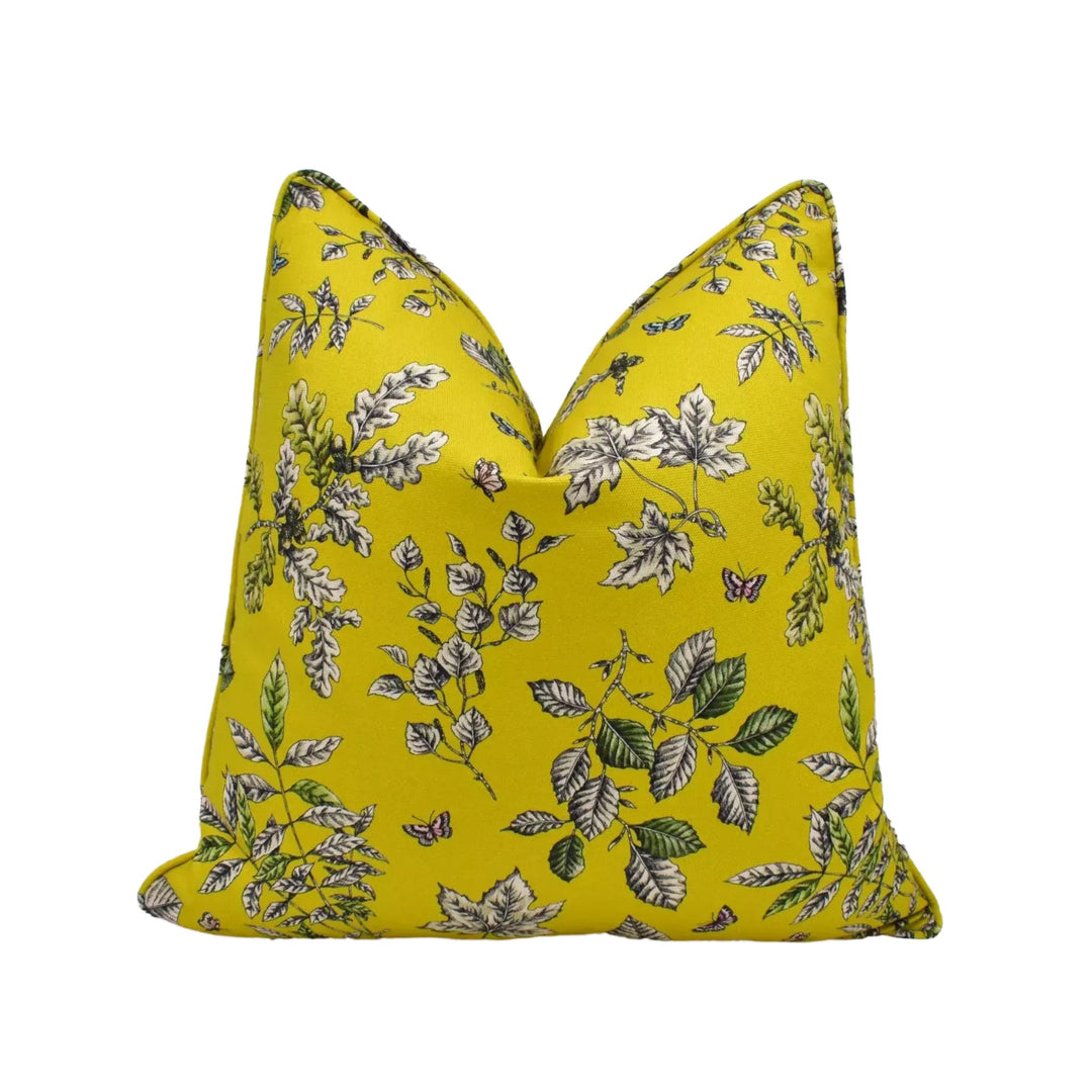 A yellow pillow with a floral print pattern.