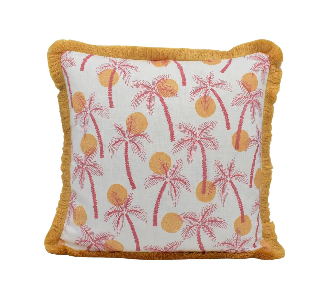 A square throw pillow with a white background and a repeating pattern of palm trees and sun-like shapes in shades of pink and orange.