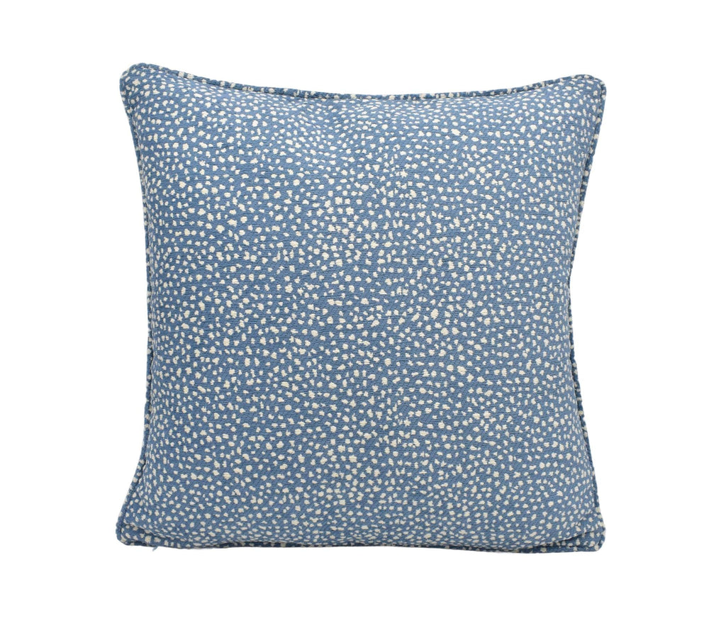 a blue pillow with white dots on it