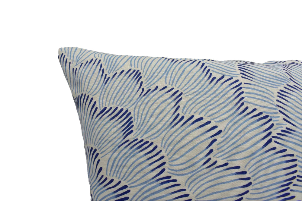 a close-up view of a decorative pillow with a blue and white striped pattern.