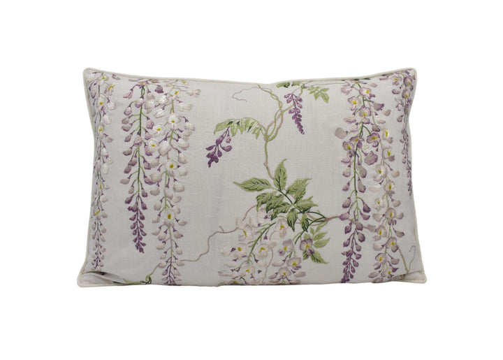 a white pillow with purple flowers on it