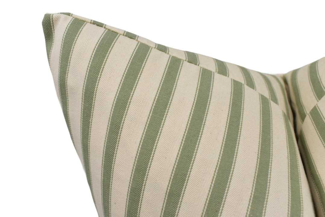 a close up of a green and white striped pillow