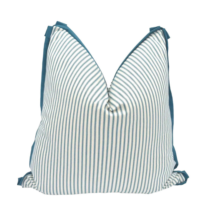 A striped pillow with a teal trim is displayed against a white background.