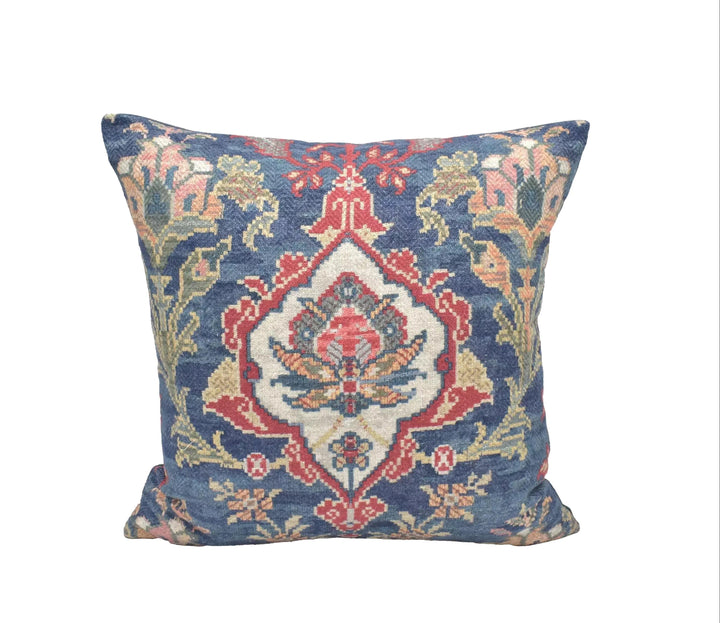 A decorative throw pillow with a vibrant, intricate pattern in shades of blue, red, and yellow.