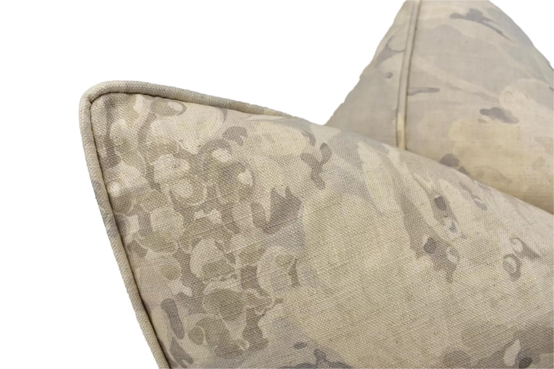 a close-up view of a beige fabric with a floral pattern, possibly a pillow or cushion.