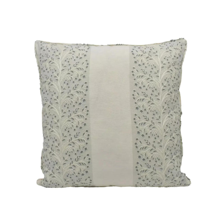 A square throw pillow with a floral pattern on the left side and a solid color on the right side.