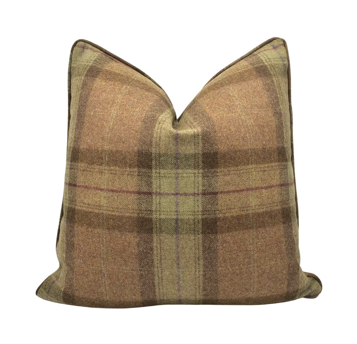 A brown plaid pillow with a checkered pattern.