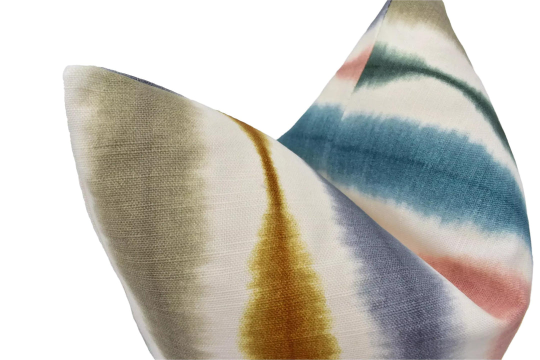 a close-up view of a colorful, tie-dye fabric with a pattern of blue, green, and yellow stripes.