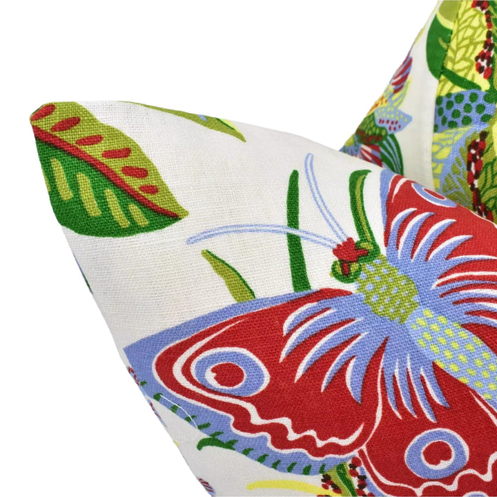 a close-up view of a colorful, patterned pillow with a butterfly design.