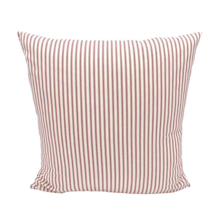 A single, square pillow with a striped pattern in shades of red and white.