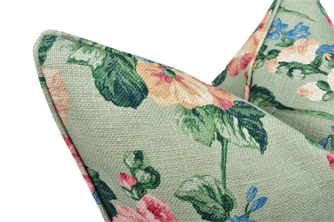a close-up view of a green fabric with a floral pattern, featuring a variety of colors including pink, green, and yellow flowers.
