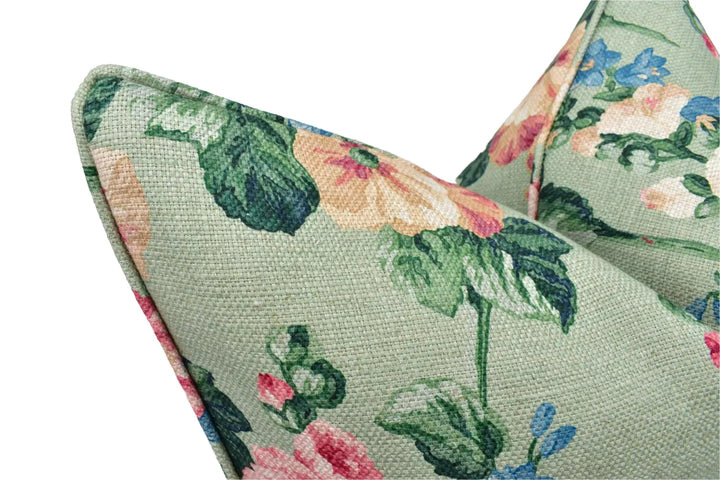 a close-up view of a green fabric with a floral pattern, featuring a variety of colors including pink, green, and yellow flowers.