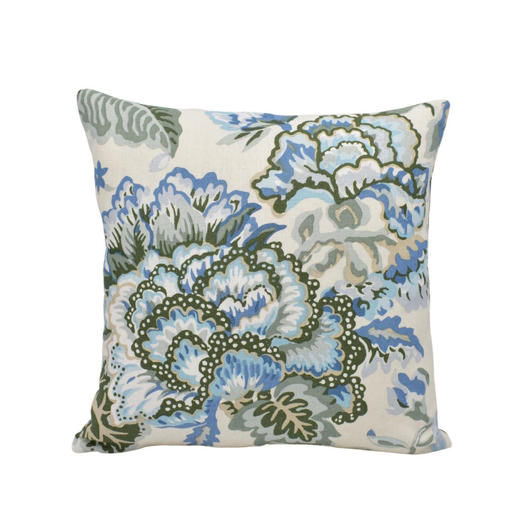 A square throw pillow with a floral pattern in shades of blue and green.