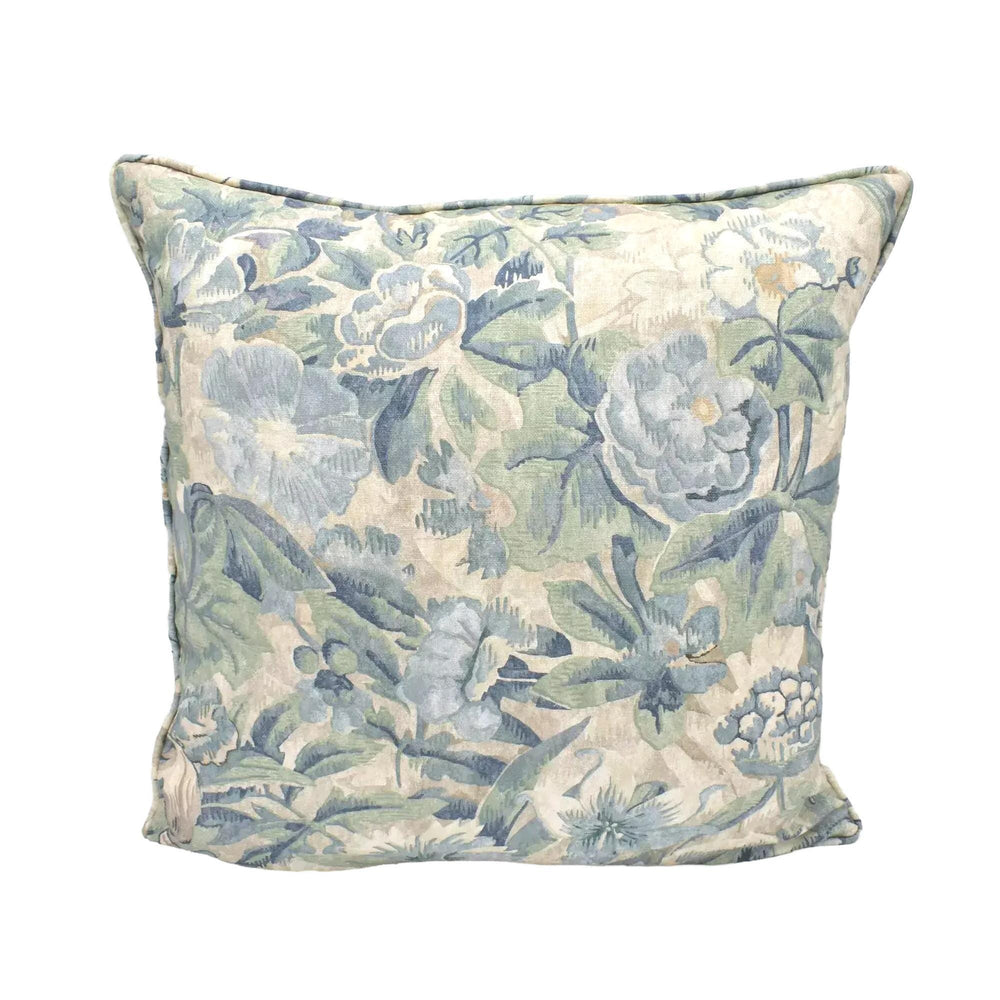 A decorative throw pillow with a floral print in shades of blue and green.