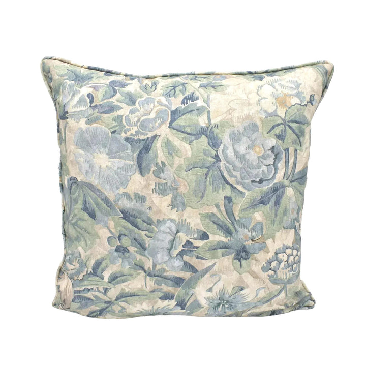 A decorative throw pillow with a floral print in shades of blue and green.